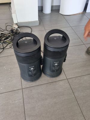 two trash cans sitting on the floor next to each other