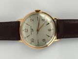 a watch that is sitting on a white surface