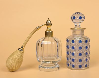 a glass bottle with a wooden handle next to a glass bottle with a wooden handle