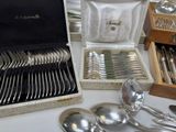 a box of silverware on a table with other silverware in it