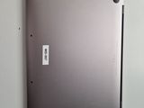 a silver laptop with a sticker on the back of it
