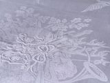 a white table cloth with a floral design on it