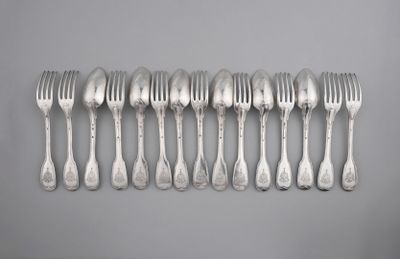 six forks are lined up in a row on a gray surface