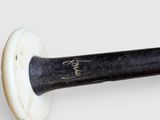 a close up of a baseball bat with a signature on it
