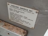 une pancarte apposée sur le côté d'une machine sur laquelle on peut lire « Harlland America Inc. »