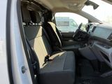 the interior of a white truck with black seats and a black seat belt