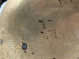 a close up of a metal object with a brown patt
