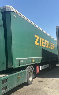 two semi trucks that are parked next to each other