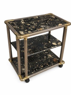 une photo d'une table noire et dorée avec un plateau en marbre
