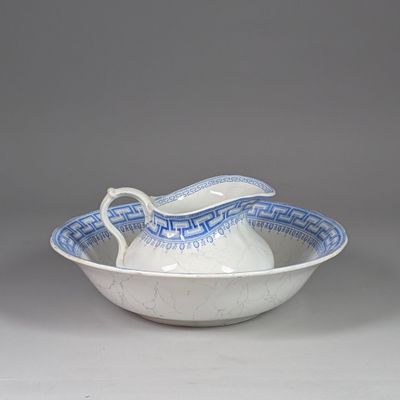 a white bowl with a blue and white pattern on it