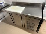 a stainless steel counter with a cutting board on top of it