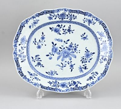 a blue and white plate with a floral design on it