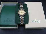 an image of a rolex watch in a box on a table