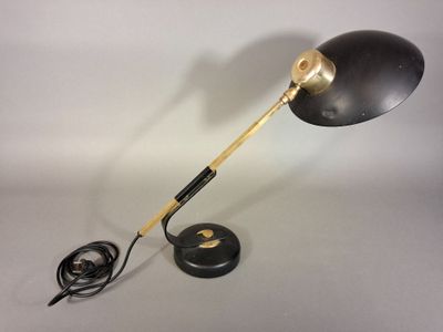 an image of a black and gold desk lamp on a white surface