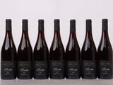 six bouteilles de vin sont alignées sur une table