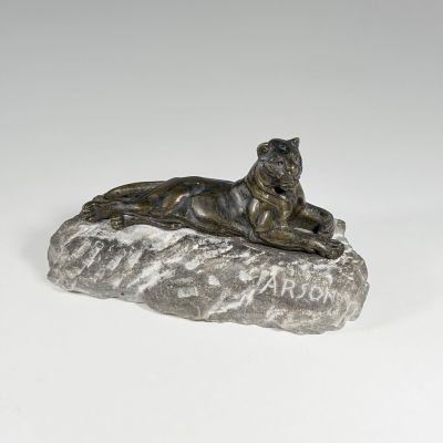 bronze statue of a tiger on a rock with the word arr on it