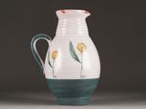 a white pitcher with yellow flowers painted on it