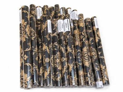a group of black and gold paper straws sitting on top of each other