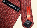 an image of a red neck tie with a black label on it