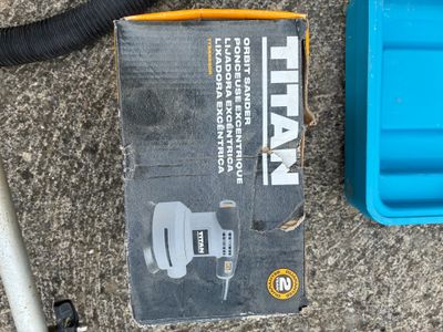 a box of tools sitting on the ground next to a blue box