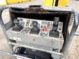 a machine that is sitting on the ground in front of a building