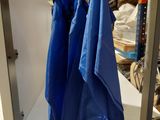 two blue bags hanging from a shelf in a store