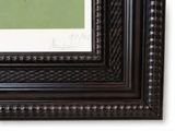 a picture of a black picture frame with a green picture in it