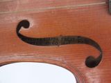 a close up of a violin that has a sign on it