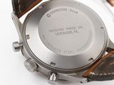 hamilton watch co watch with brown leather strap on a white surface