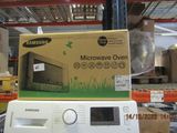 a microwave oven sitting on top of a shelf in a store