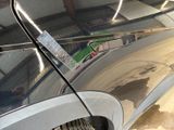 a close up of a car door handle with a sticker on it
