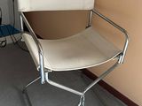 a white chair that is sitting in the corner of a room