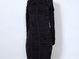 the mannequin is wearing a black dress with ruffled sleeves