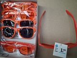 many pairs of sunglasses in a box with a price tag