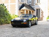 a black sports car parked in front of a large house