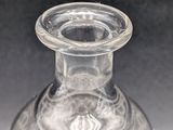 a clear glass vase with a black background