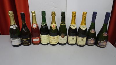 bottles of wine lined up on a table in front of a red curtain