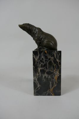 statue of a seal sitting on a marble block on a white background