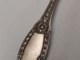 a close up of a spoon on a table with a white background