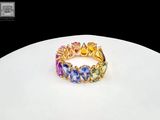 an image of a ring with multi colored stones on a white surface