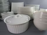 many white dishes and bowls on the table
