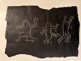 drawing of a group of stick figures on a piece of black paper