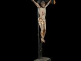 a statue of jesus on the cross on a black background