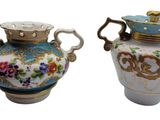 two vases sitting side by side on a white surface