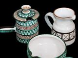 three different types of teapots and cups on the table