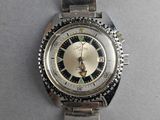an image of a silver watch with a black and white face