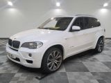 a picture of a white bmw suv parked on a checkered floor