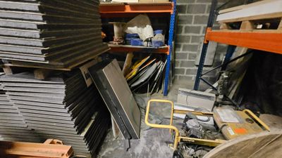 a pile of metal items in a room with shelves