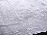 a bed with a white comforter and a pillow on it