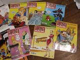 a lot of comic books on the table